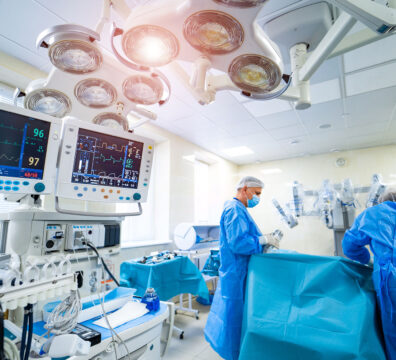 Process of trauma surgery operation. Group of surgeons in operating room with surgery equipment. Medical background, selective focus