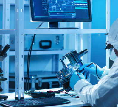 Professional African-American scientist works in a modern scientific laboratory for the research and development of microelectronics and processors. Microprocessor manufacturing worker uses computer technology and equipment.