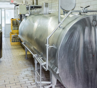 Liquid storage tank and pipe in the dairy for the production of Gruyere de Comte Cheese in Franche Comte, Burgundy, of France.